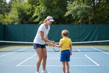 Tennis coaching session with a young player