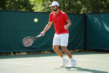 Intermediate tennis player hitting a powerful forehand